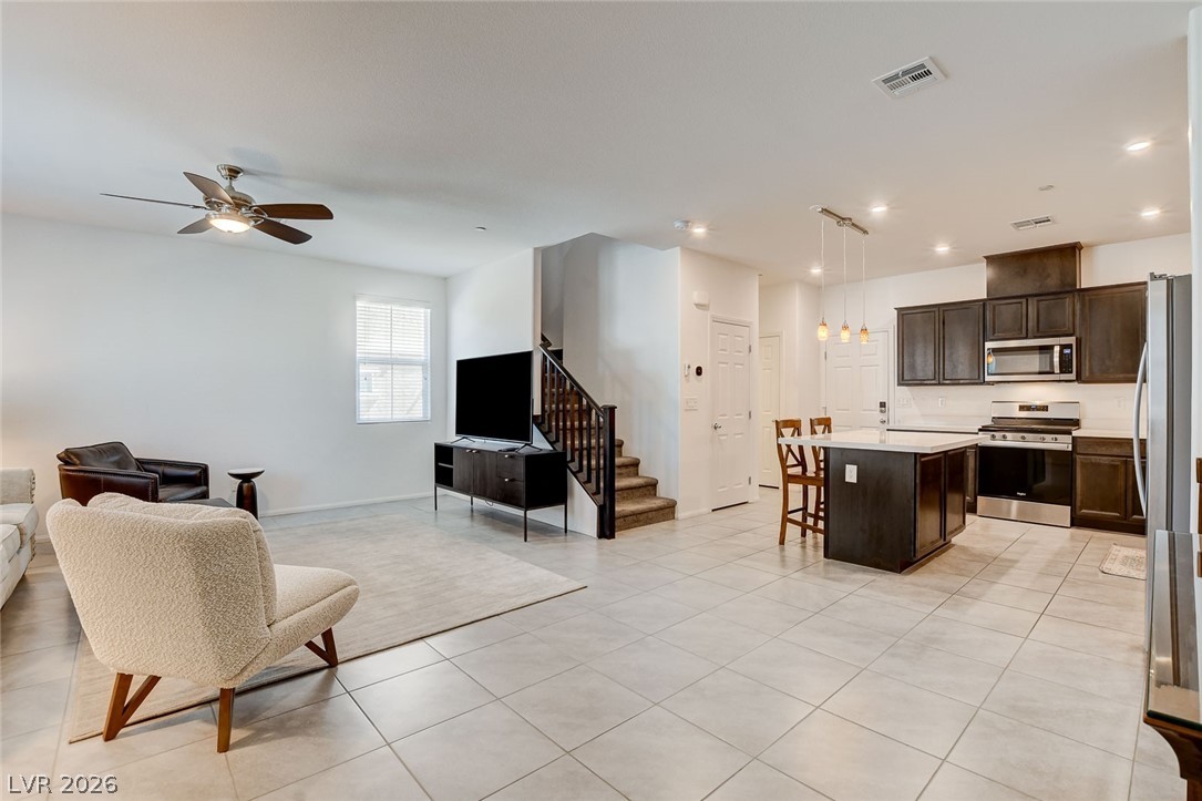484 Filaree Place Henderson, NV 89015 - Photo 7 of 71 An inviting open-concept living area seamlessly connects to a modern kitchen and dining space.