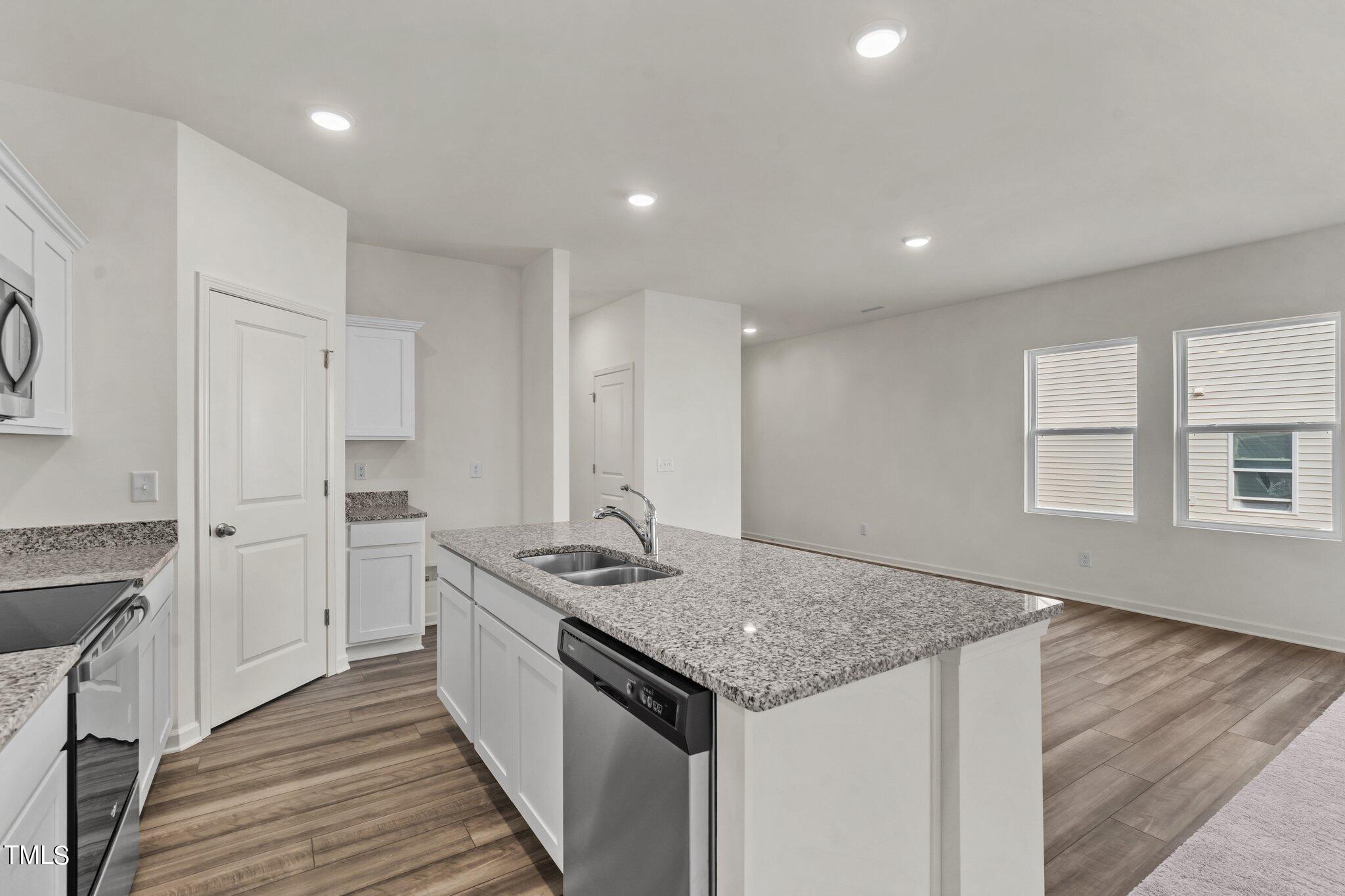 730 Piaggio Lane Spring Hope, NC 27882 - Photo 9 of 25 a kitchen with stainless steel appliances granite countertop a sink stove and cabinets