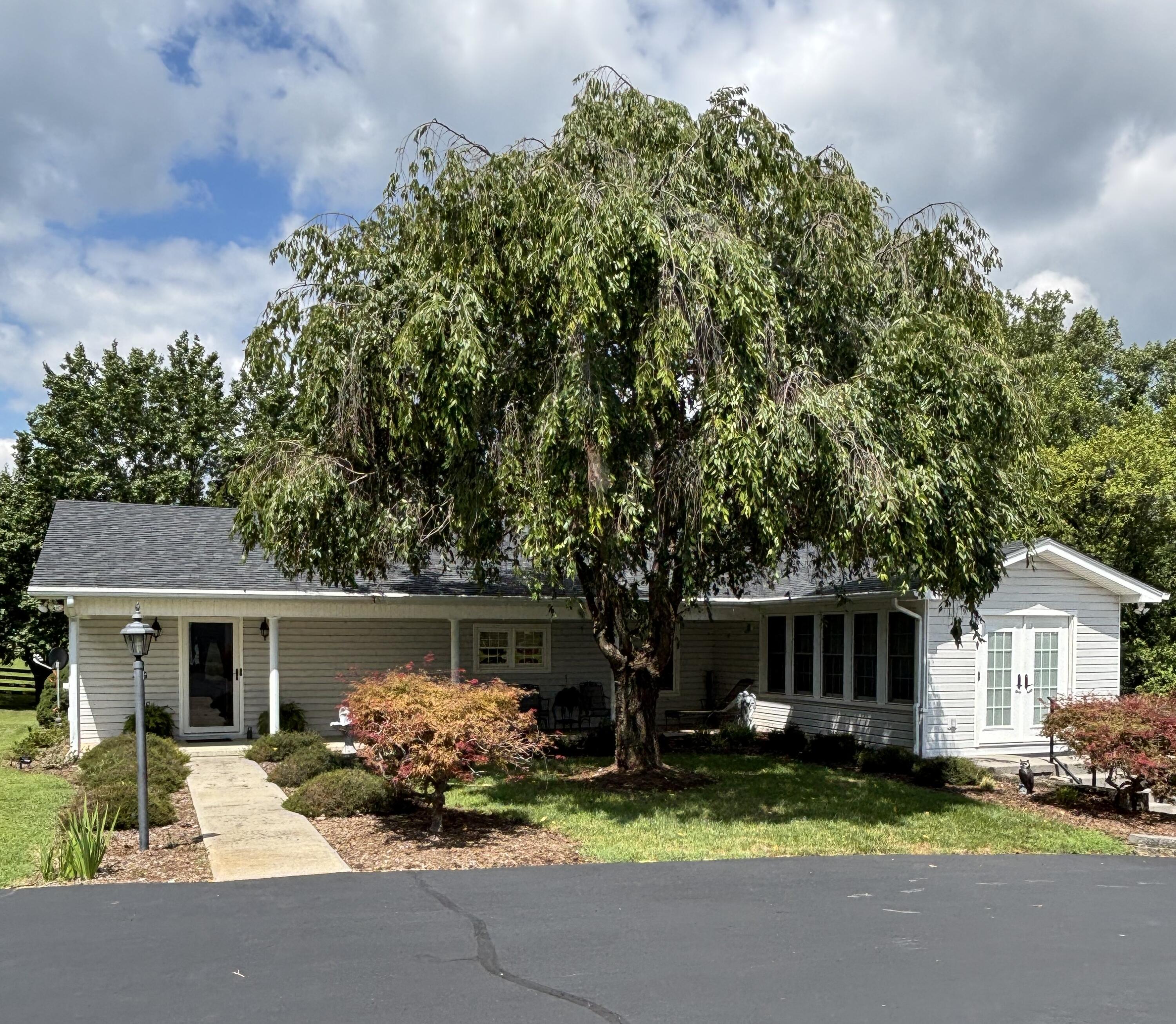 1235 Rock Spring Road Goodview, VA 24095 - Photo 1 of 62 a front view of a house with a yard and garage