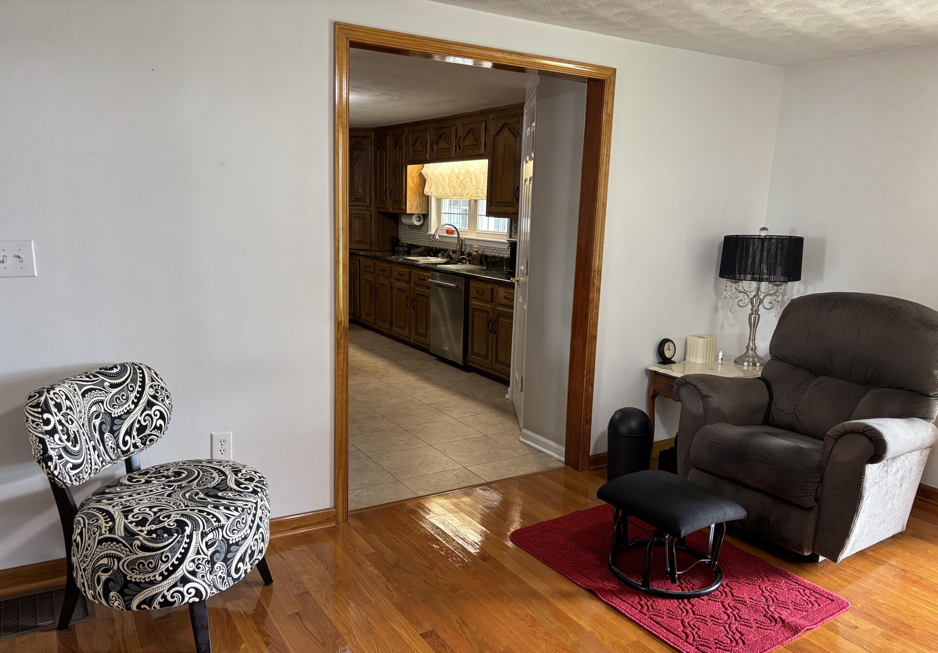 1235 Rock Spring Road Goodview, VA 24095 - Photo 14 of 62 a living room with furniture and a wooden floor
