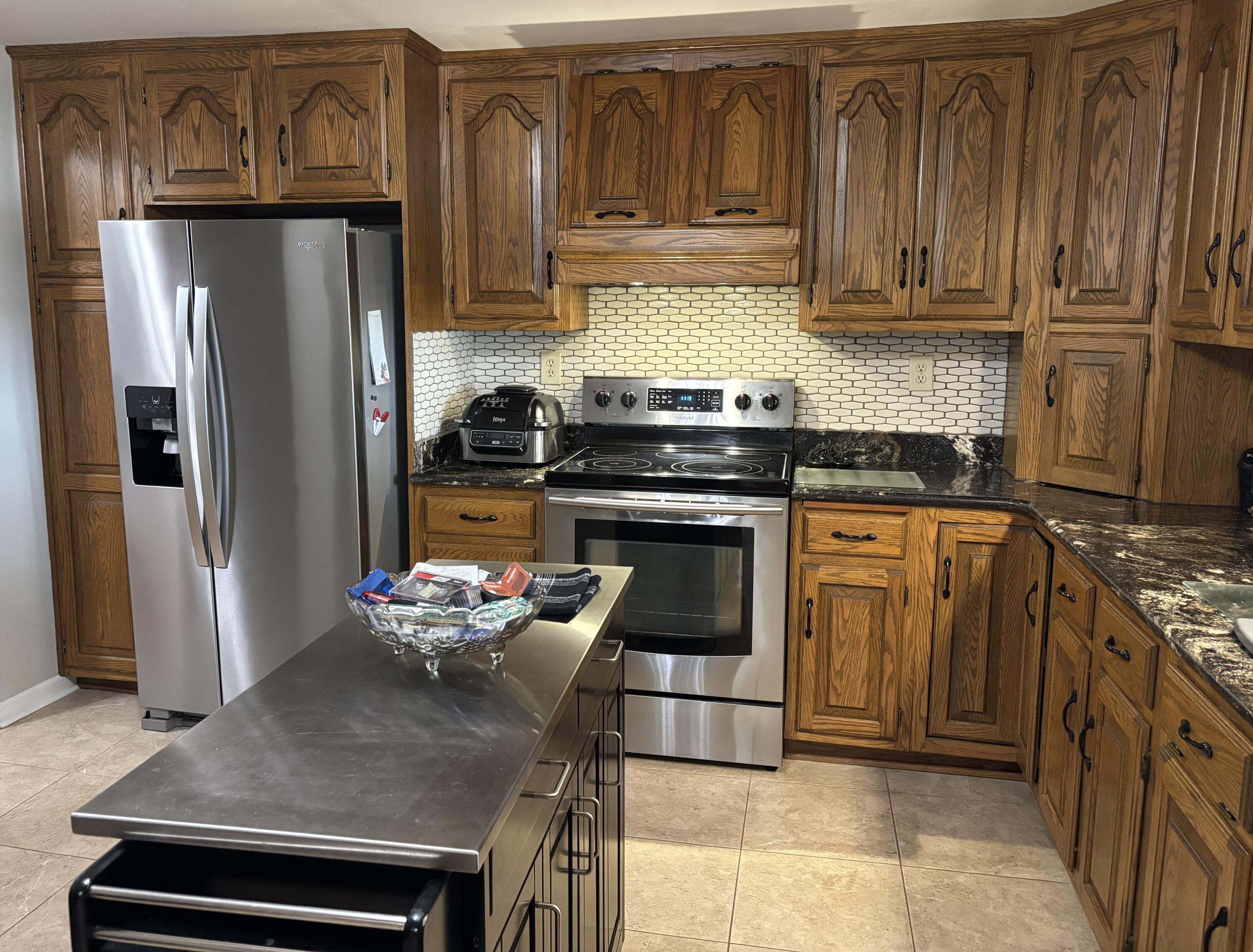 1235 Rock Spring Road Goodview, VA 24095 - Photo 16 of 62 a kitchen with stainless steel appliances granite countertop a refrigerator stove and sink