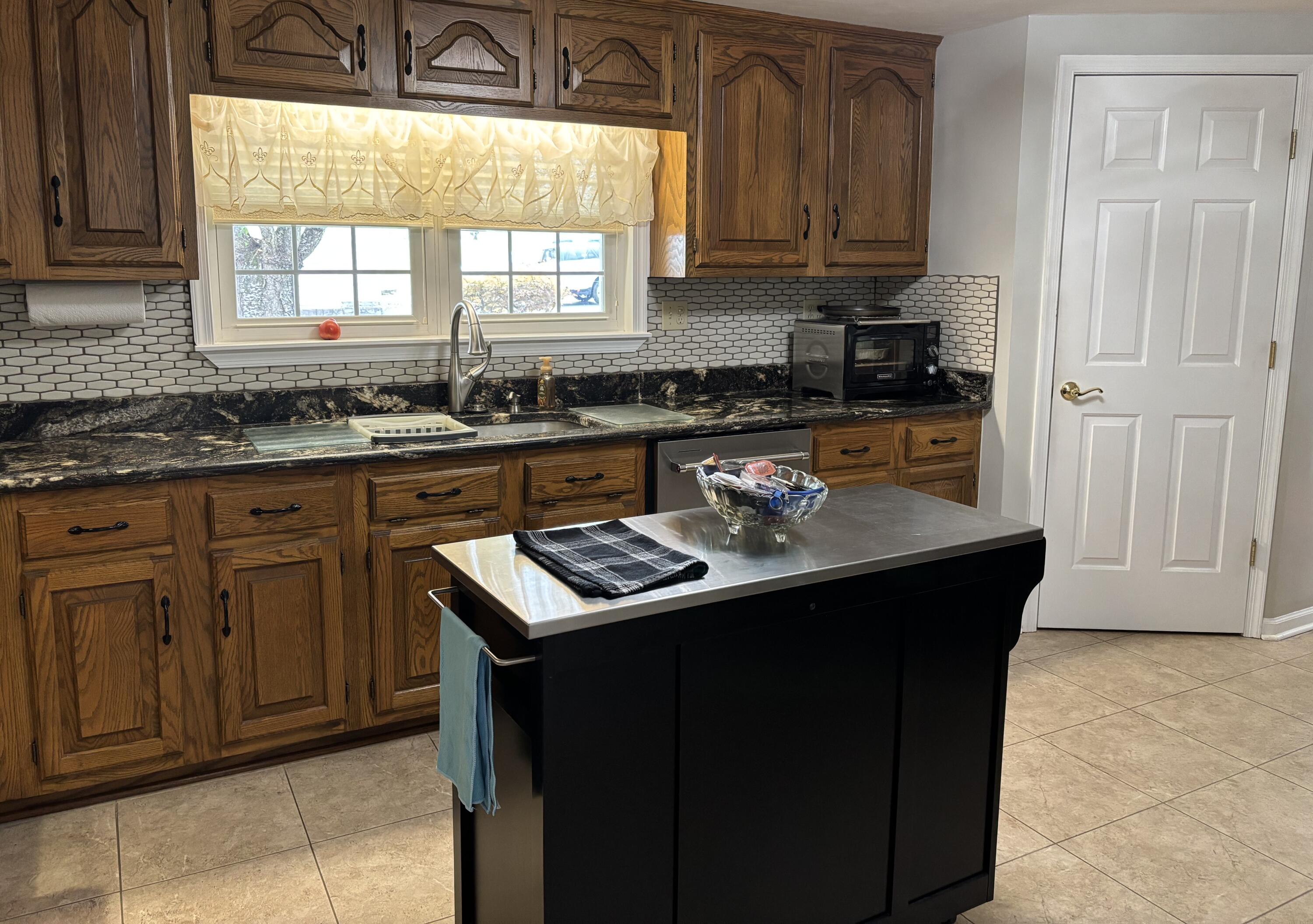1235 Rock Spring Road Goodview, VA 24095 - Photo 18 of 62 a kitchen with sink cabinets and window