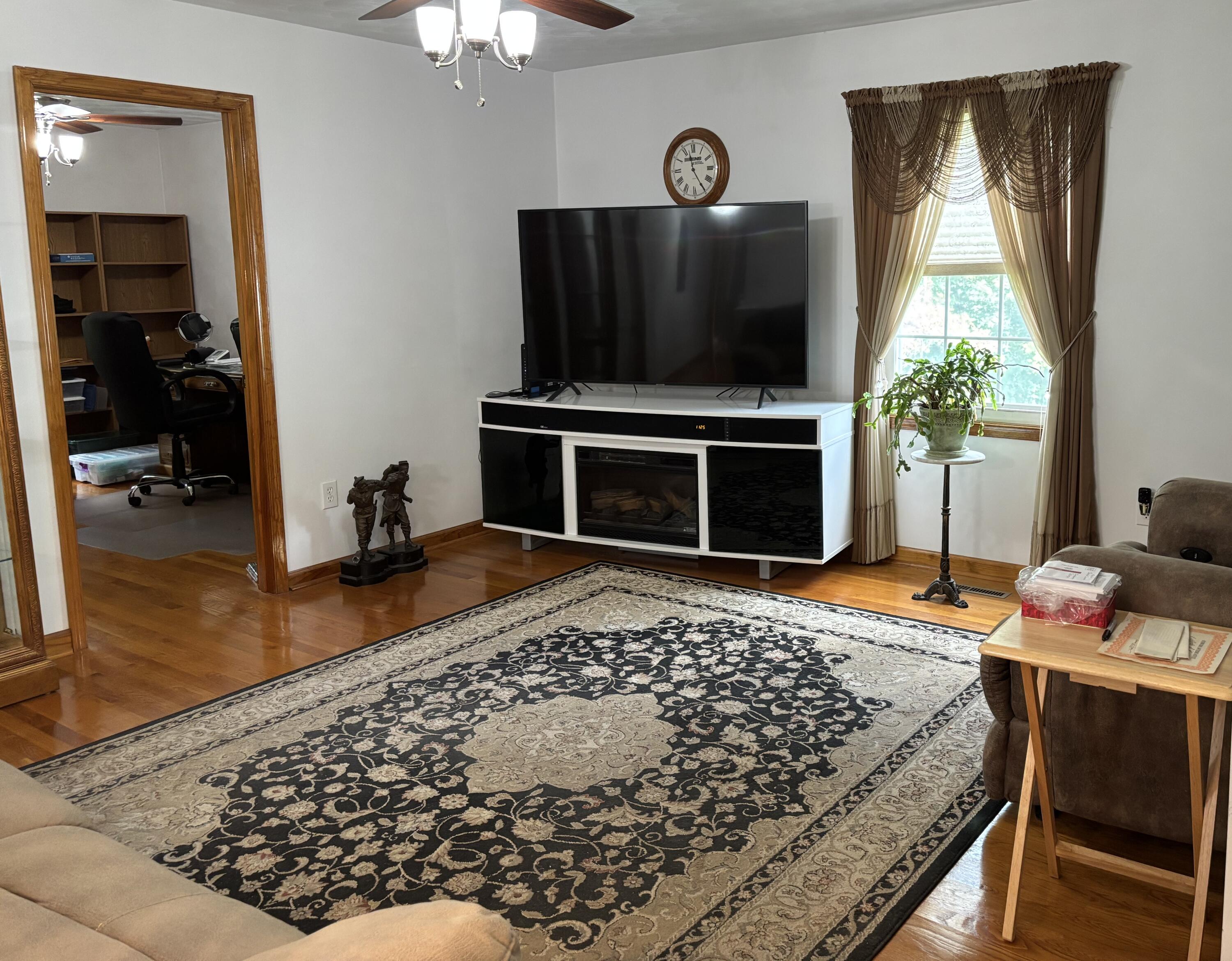 1235 Rock Spring Road Goodview, VA 24095 - Photo 26 of 62 a living room with furniture fireplace and flat screen tv