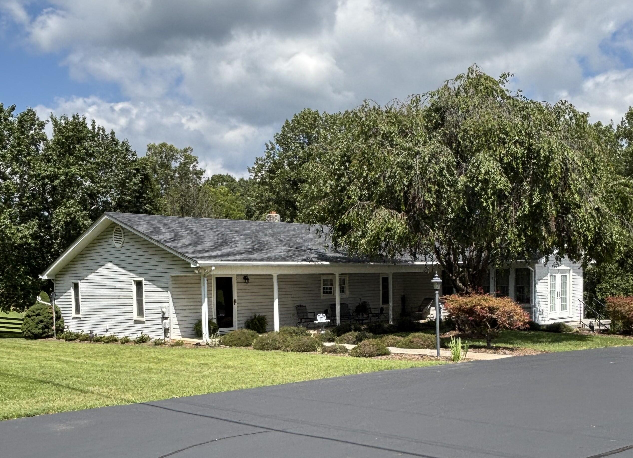 1235 Rock Spring Road Goodview, VA 24095 - Photo 3 of 62 a view of a house with a yard and large trees