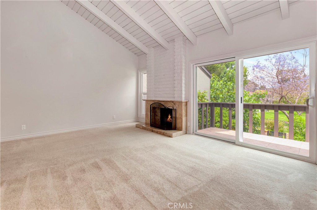 4625 Green Tree Lane Irvine, CA 92612 - Photo 11 of 29 a view of an empty room with a fireplace and a window