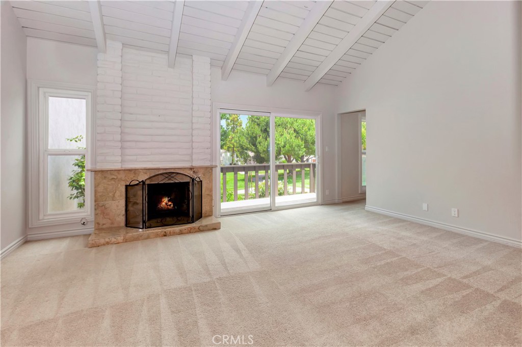 4625 Green Tree Lane Irvine, CA 92612 - Photo 12 of 29 an empty room with windows and fireplace