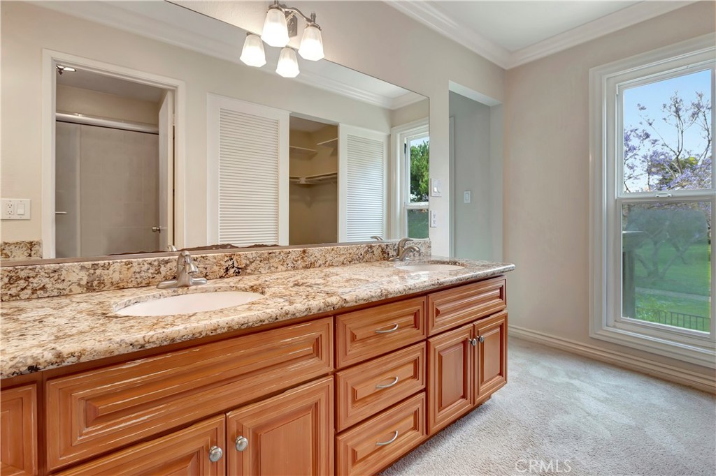4625 Green Tree Lane Irvine, CA 92612 - Photo 14 of 29 a bathroom with a granite countertop double vanity sink and mirror