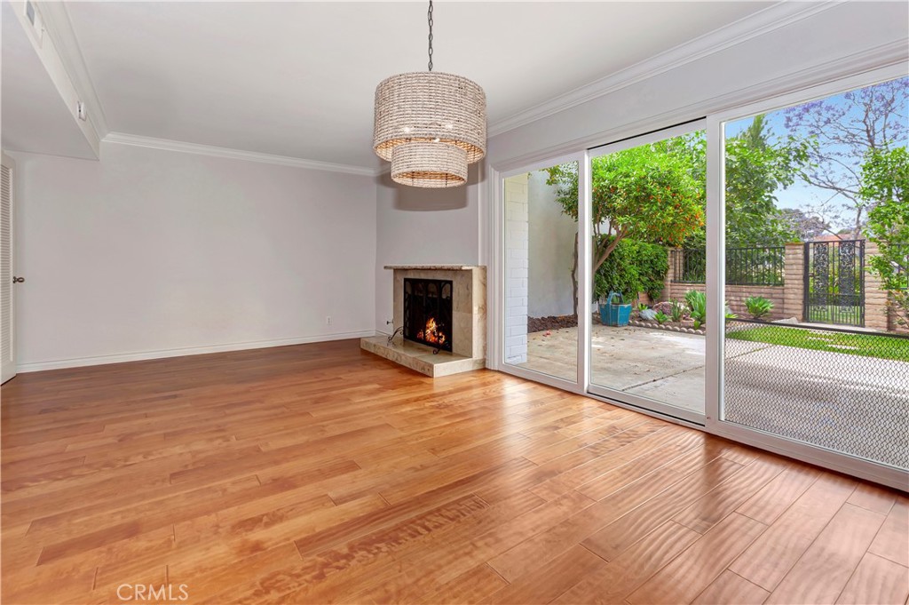 4625 Green Tree Lane Irvine, CA 92612 - Photo 10 of 29 a view of empty room with wooden floor and fireplace