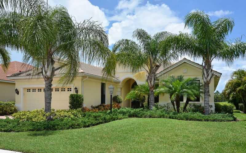 13950 Siena Loop Lakewood Ranch, FL 34202 - Photo 1 of 1 front view of house with a yard and palm trees