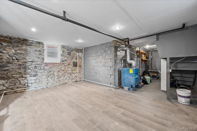 a view of a storage room with water heater and stairs