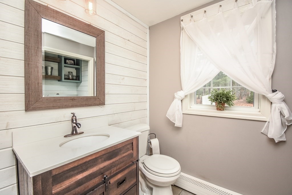26 Rush Pond Road Lakeville, MA 02347 - Photo 14 of 38 a bathroom with a sink a toilet and mirror