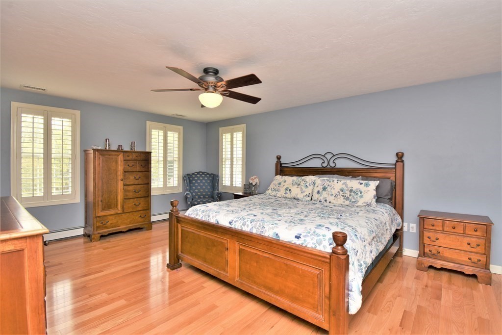 26 Rush Pond Road Lakeville, MA 02347 - Photo 19 of 38 a spacious bedroom with a bed and a chandelier