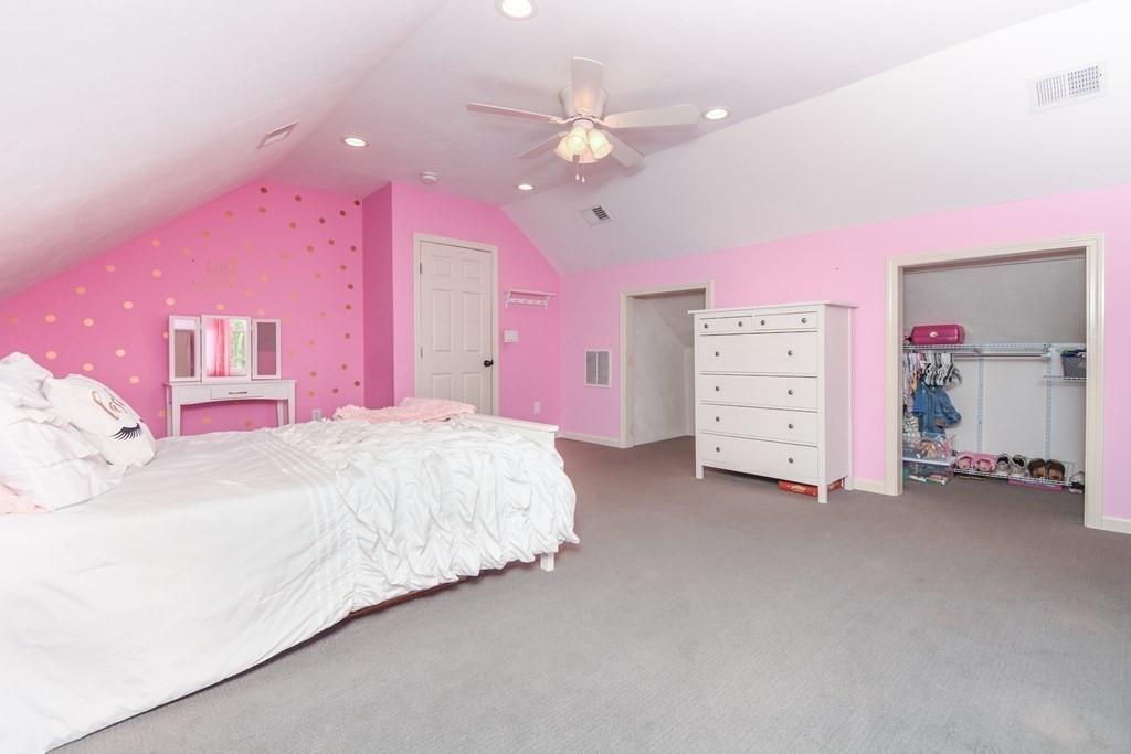 26 Rush Pond Road Lakeville, MA 02347 - Photo 28 of 38 a spacious bedroom with a bed dresser and a chandelier