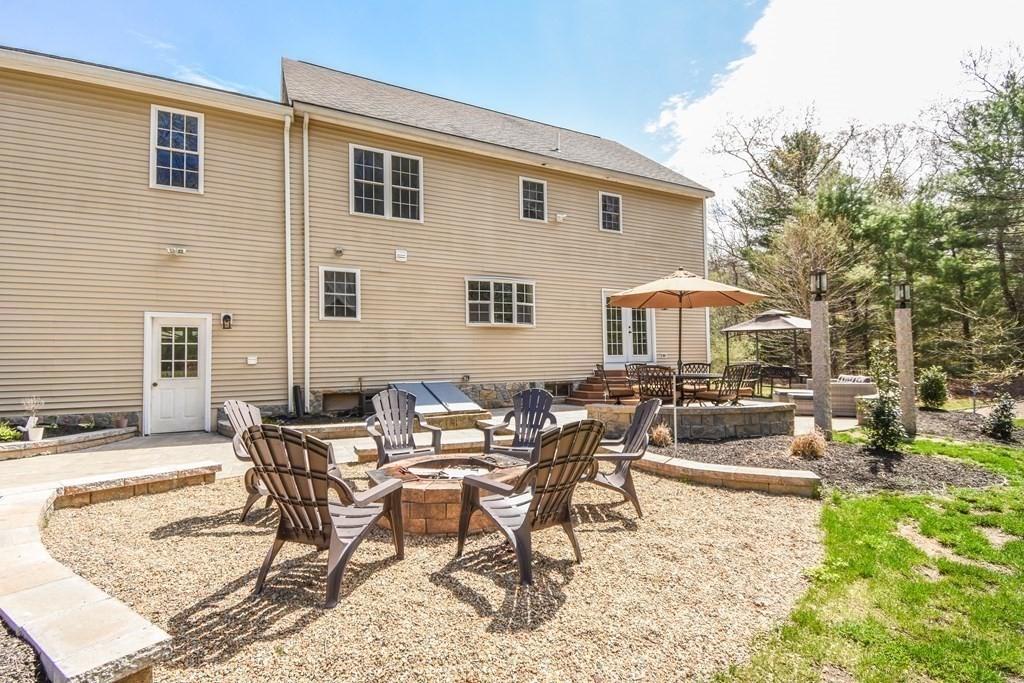 26 Rush Pond Road Lakeville, MA 02347 - Photo 30 of 38 a view of a dinning table and chairs in the patio