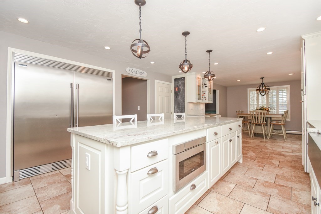 26 Rush Pond Road Lakeville, MA 02347 - Photo 3 of 38 a large kitchen with kitchen island a large counter top a sink and stainless steel appliances