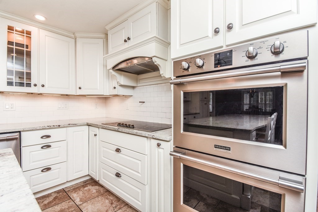 26 Rush Pond Road Lakeville, MA 02347 - Photo 5 of 38 a kitchen with granite countertop white cabinets and white appliances