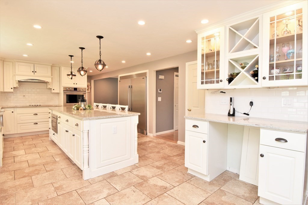 26 Rush Pond Road Lakeville, MA 02347 - Photo 6 of 38 a kitchen with a sink a stove a refrigerator and white cabinets with wooden floor