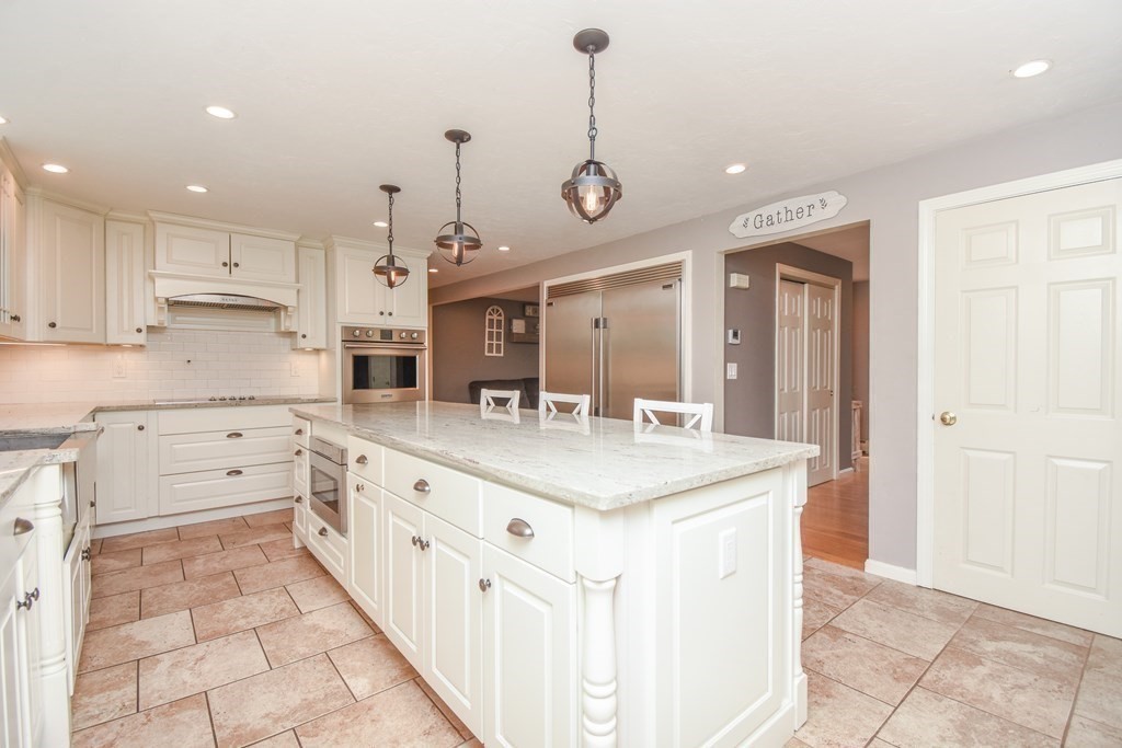 26 Rush Pond Road Lakeville, MA 02347 - Photo 7 of 38 a kitchen with kitchen island granite countertop a sink a stove top oven a counter space and cabinets