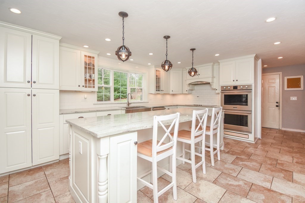 26 Rush Pond Road Lakeville, MA 02347 - Photo 8 of 38 a kitchen with kitchen island granite countertop a table and chairs in it