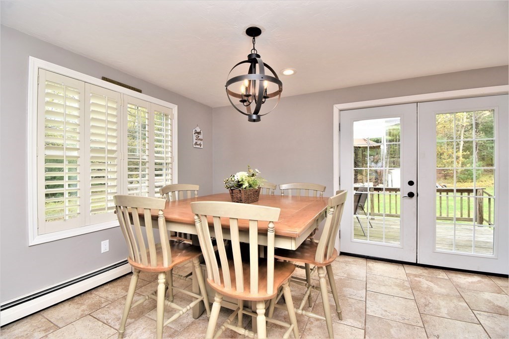 26 Rush Pond Road Lakeville, MA 02347 - Photo 10 of 38 a dining room with furniture a chandelier and wooden floor