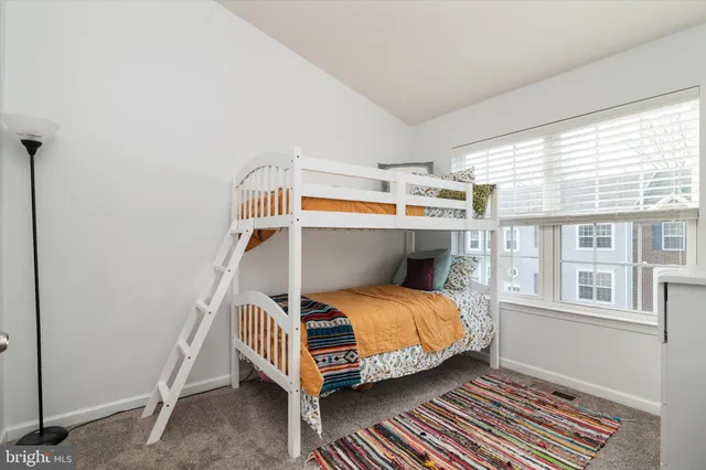 a bedroom with a bed and windows