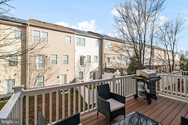 a view of a brick house with large windows and furniture