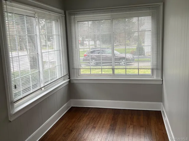 a view of a room with wooden floor and windows