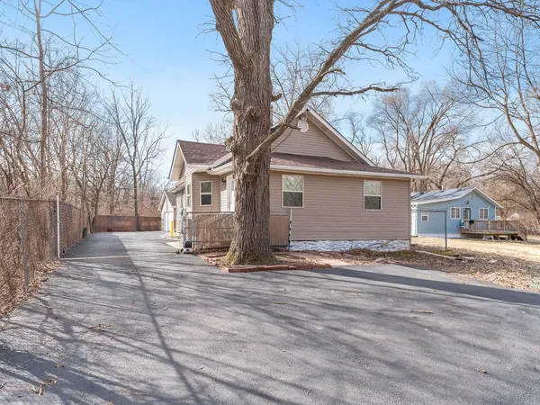 a view of a house with a yard covered in snow