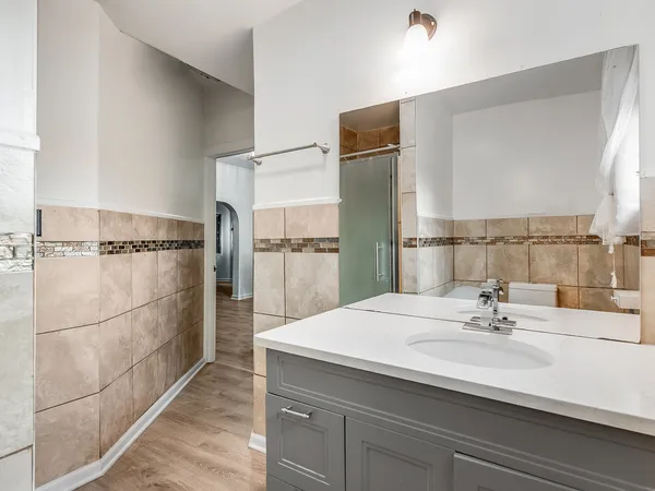 a bathroom with a sink a toilet and shower