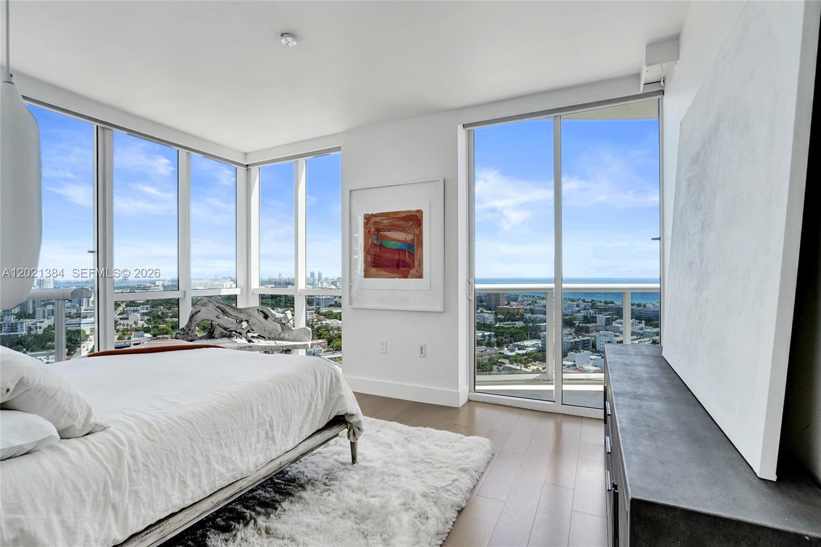 400 Alton Road, Unit PH11 Miami Beach, FL 33139 - Photo 26 of 49 a spacious bedroom with a large bed and a large window