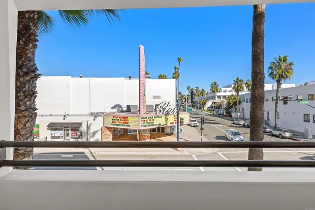 a bathroom with a granite countertop sink a toilet and a mirror