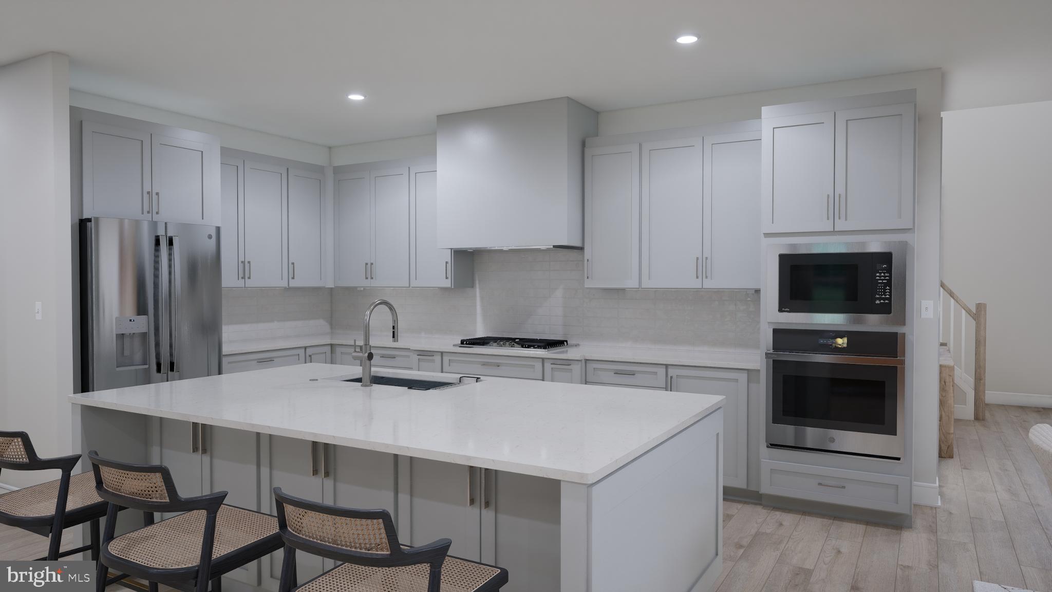Orchard Grove, Unit STONE Brambleton, VA 20148 - Photo 28 of 53 a kitchen with a sink a stove a refrigerator and white cabinets