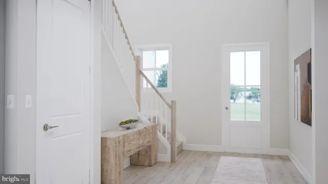 a kitchen with a table chairs refrigerator and cabinets