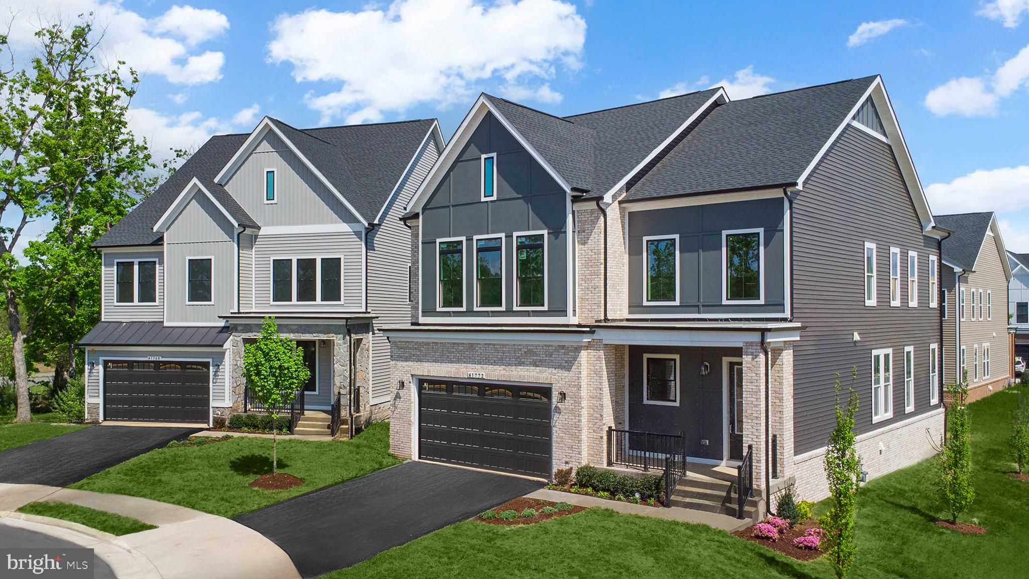 Orchard Grove, Unit STONE Brambleton, VA 20148 - Photo 47 of 53 a front view of a house with a yard