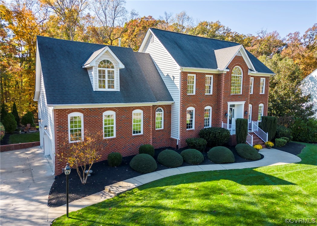 a front view of house and yard with green space