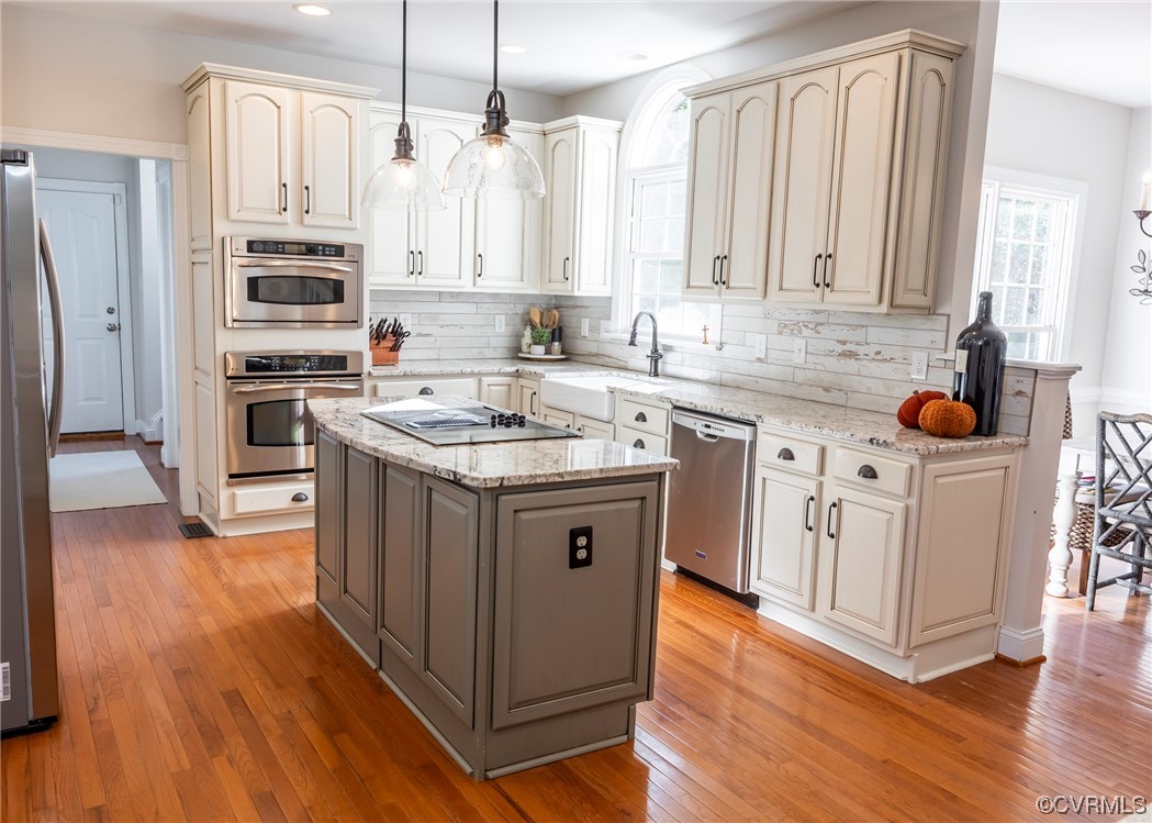 14506 Post Mill Drive Midlothian, VA 23113 - Photo 20 of 48 a kitchen with stainless steel appliances granite countertop a stove top oven a refrigerator a sink and dishwasher with wooden floor