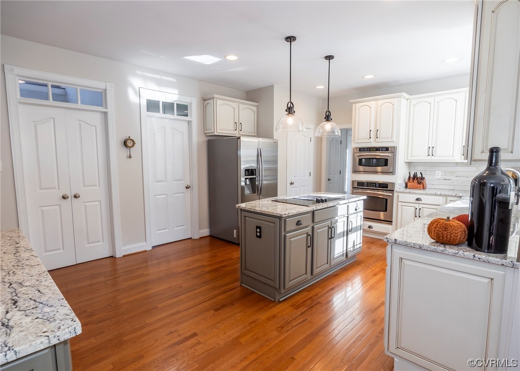 14506 Post Mill Drive Midlothian, VA 23113 - Photo 23 of 48 a kitchen with stainless steel appliances granite countertop a refrigerator a stove and a wooden floors