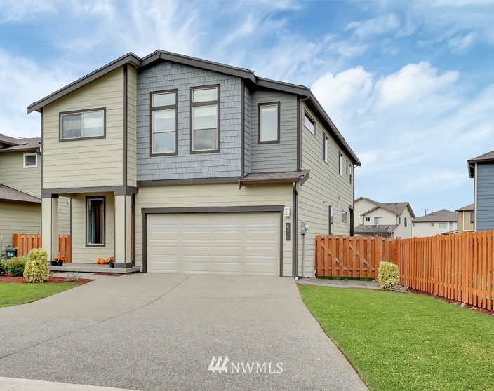 471 Partlon Street Buckley, WA 98321 - Photo 1 of 23 a front view of a house with a yard and garage