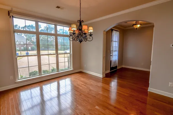 a view of a room with wooden floor and a window