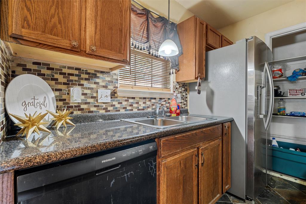 1012 Hatton Street Waco, TX 76704 - Photo 5 of 13 a kitchen with granite countertop stainless steel appliances a sink and cabinets