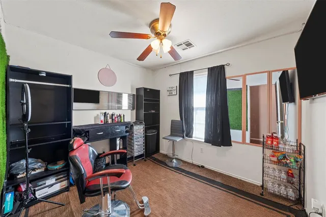 a living room with furniture a flat screen tv and kitchen view