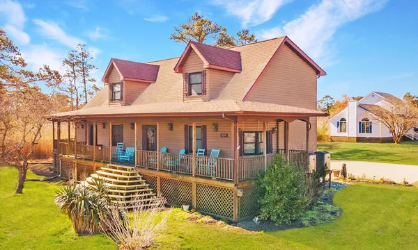 a front view of a house with a yard patio and swimming pool