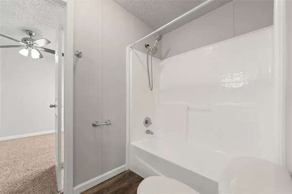 a bathroom with a shower a bathtub and a shower