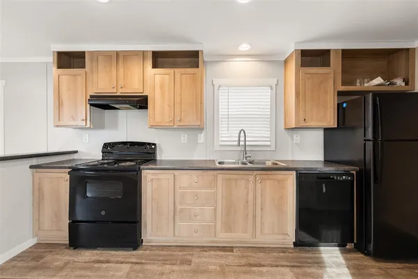 a kitchen with granite countertop a stove a sink and a microwave