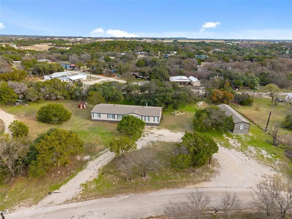 an aerial view of residential houses with outdoor space and river