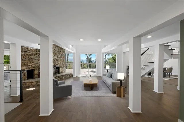 a view of a living room kitchen and a large window