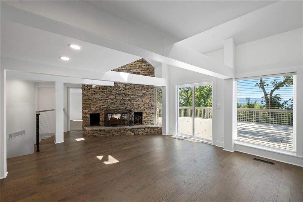 62 Bear Cub Ridge Big Canoe, GA 30143 - Photo 14 of 35 a view of an empty room with wooden floor fireplace and a window