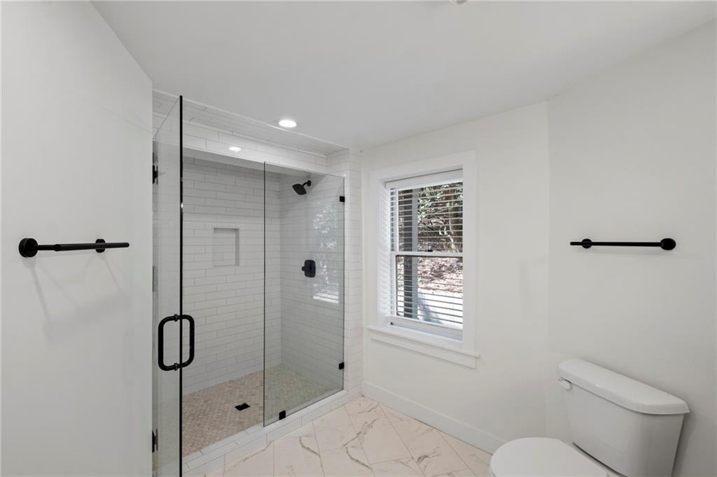 62 Bear Cub Ridge Big Canoe, GA 30143 - Photo 21 of 35 a bathroom with a granite countertop toilet a sink and shower