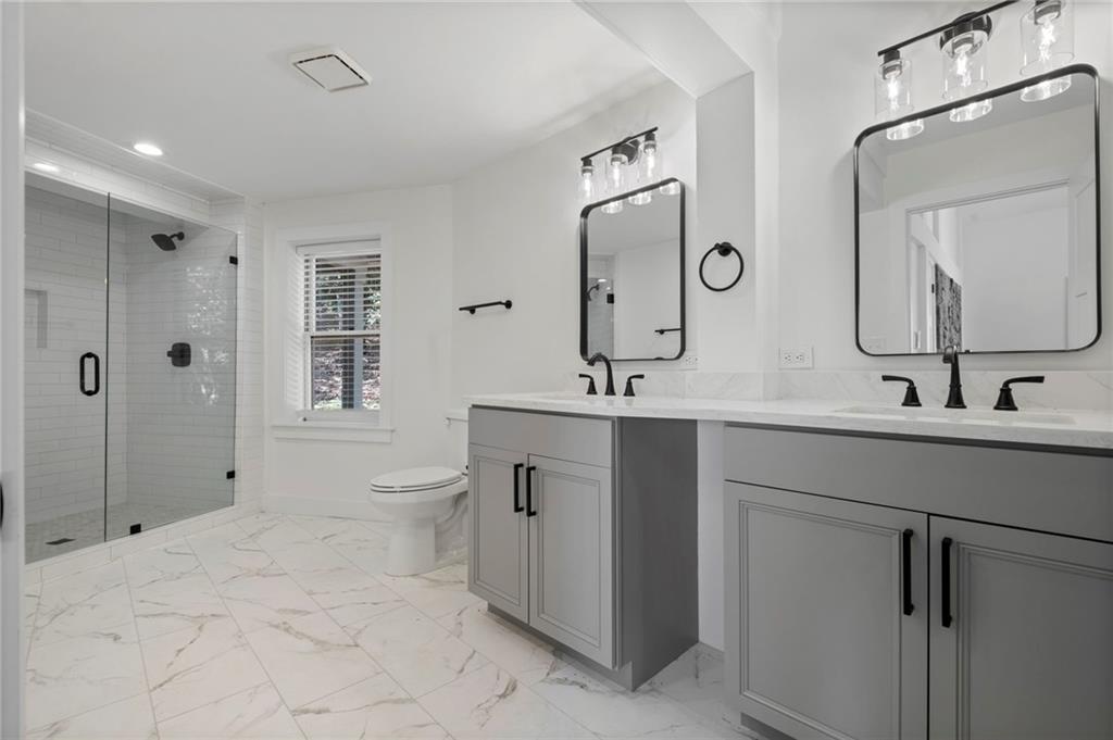 62 Bear Cub Ridge Big Canoe, GA 30143 - Photo 8 of 35 a bathroom with a double vanity sink mirror and toilet