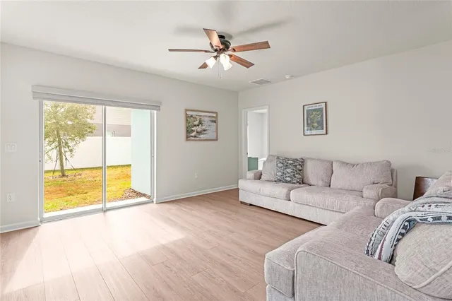 a living room with couches and painting on the wall